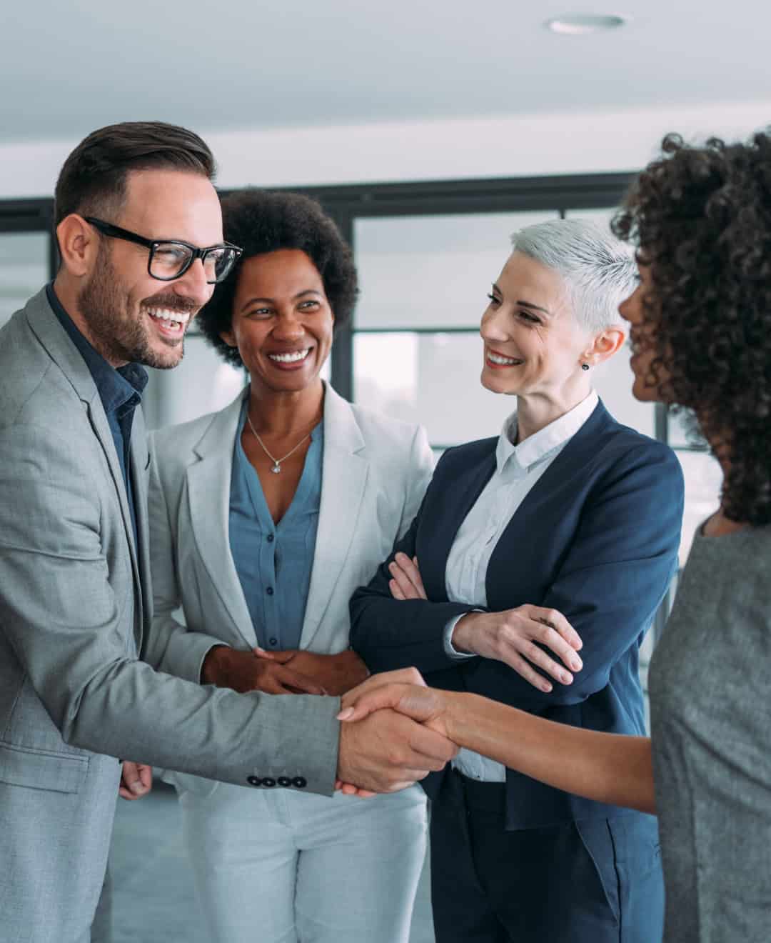 Business people shaking hands in an office.